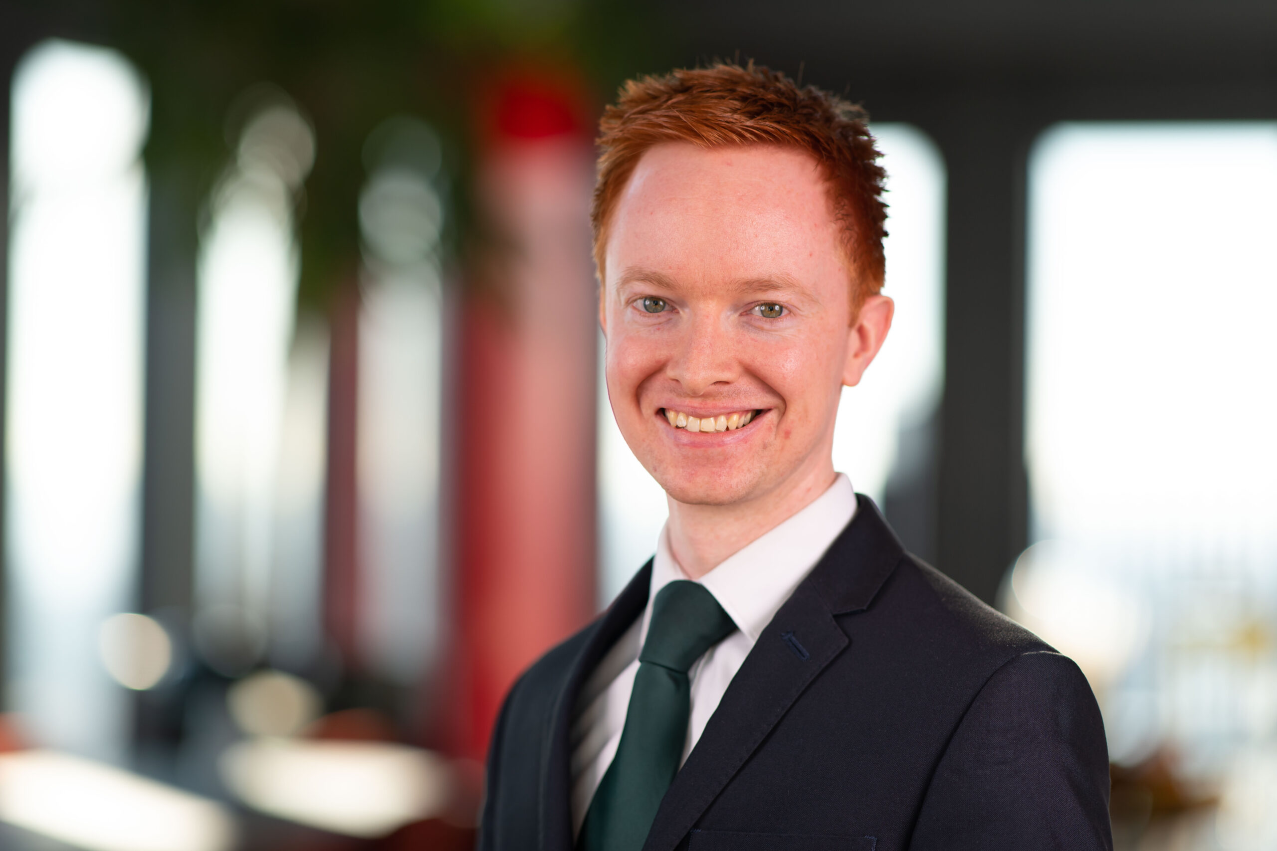 Head shot of Aidan Lloyd wearing a suit and tie