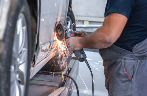 car mechanic using hand tool creating sparks