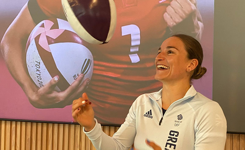 Jasmine Joyce throws a rugby ball into the air at the NatWest "Powering up your future" event held at the Hugh James 2 Central Square headquarters